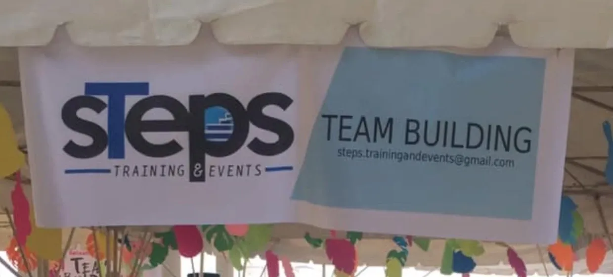 Steps Training & Events team building banner at an event tent