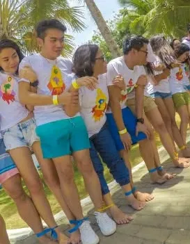 A team with legs tied together walking in step during a challenge