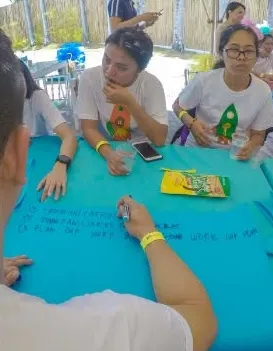 Participants writing their team plan together on a large sheet